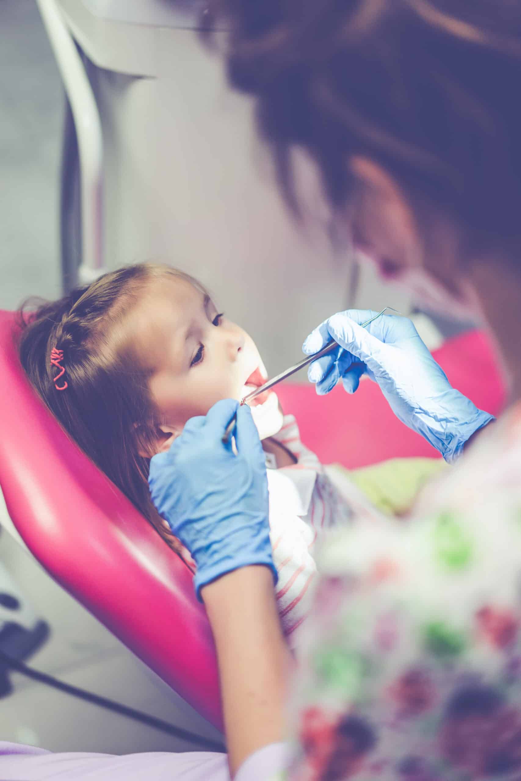 pediatric dentist. Little girl at the reception at the dentist.